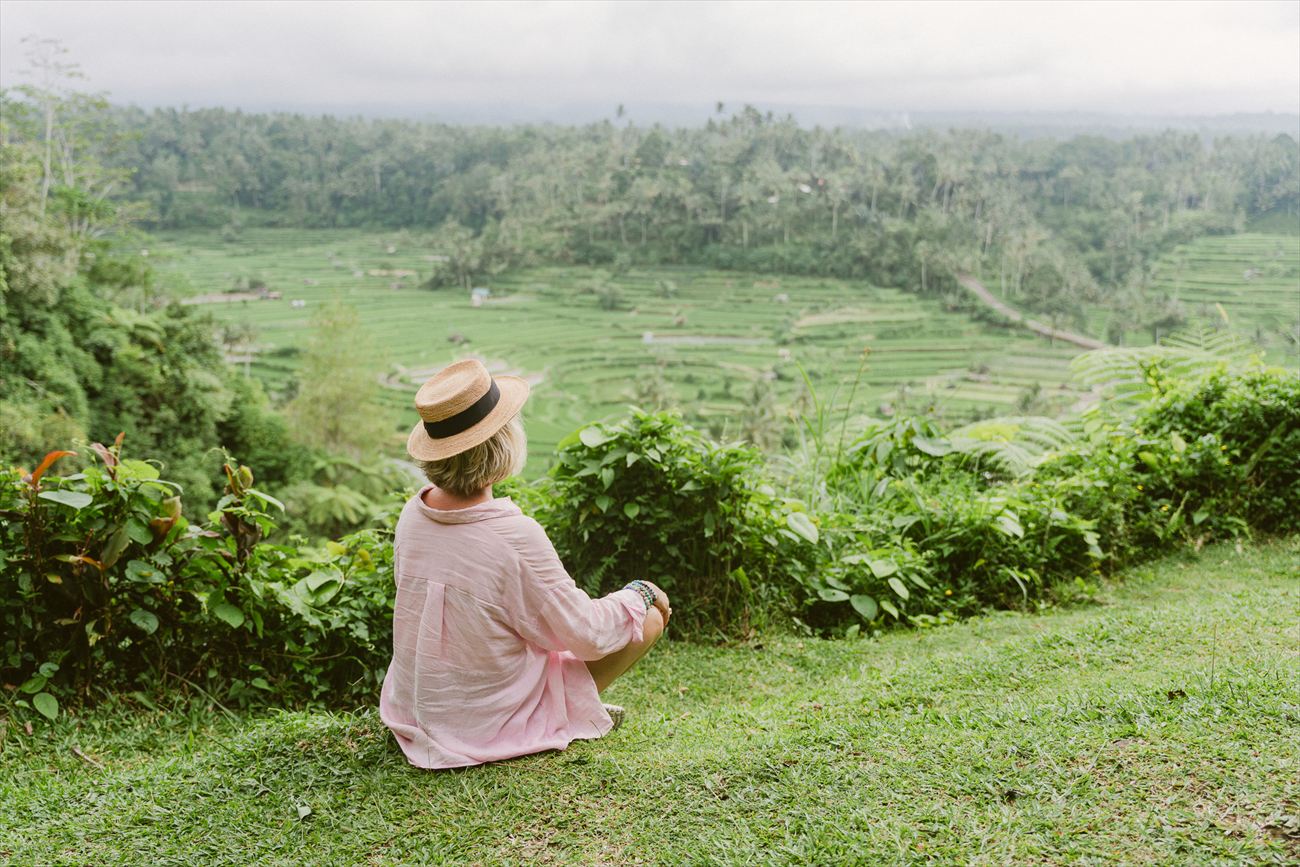 Sitting in a straw hat above the rice terraces