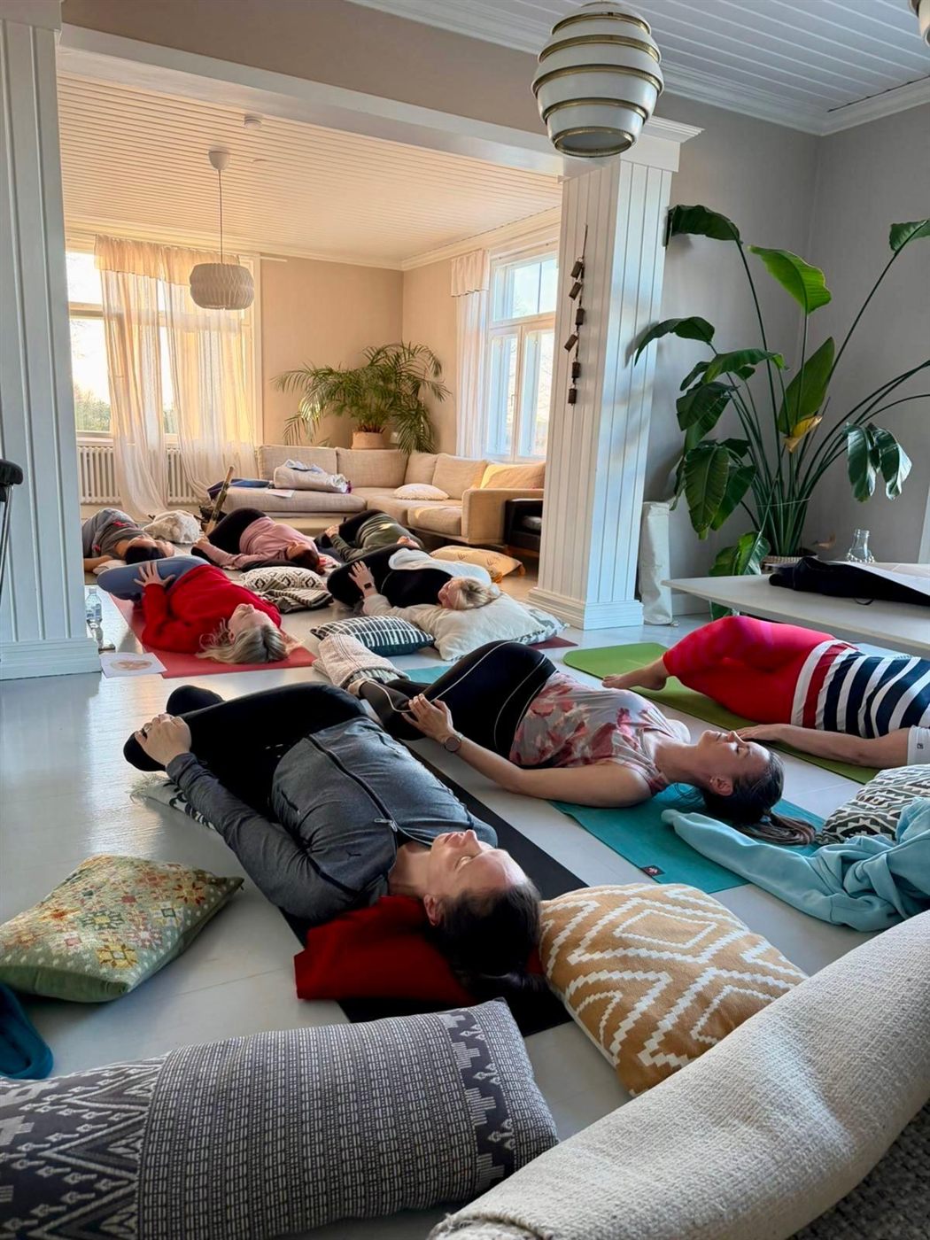 A room full of people lying down under blankets, resting after practice