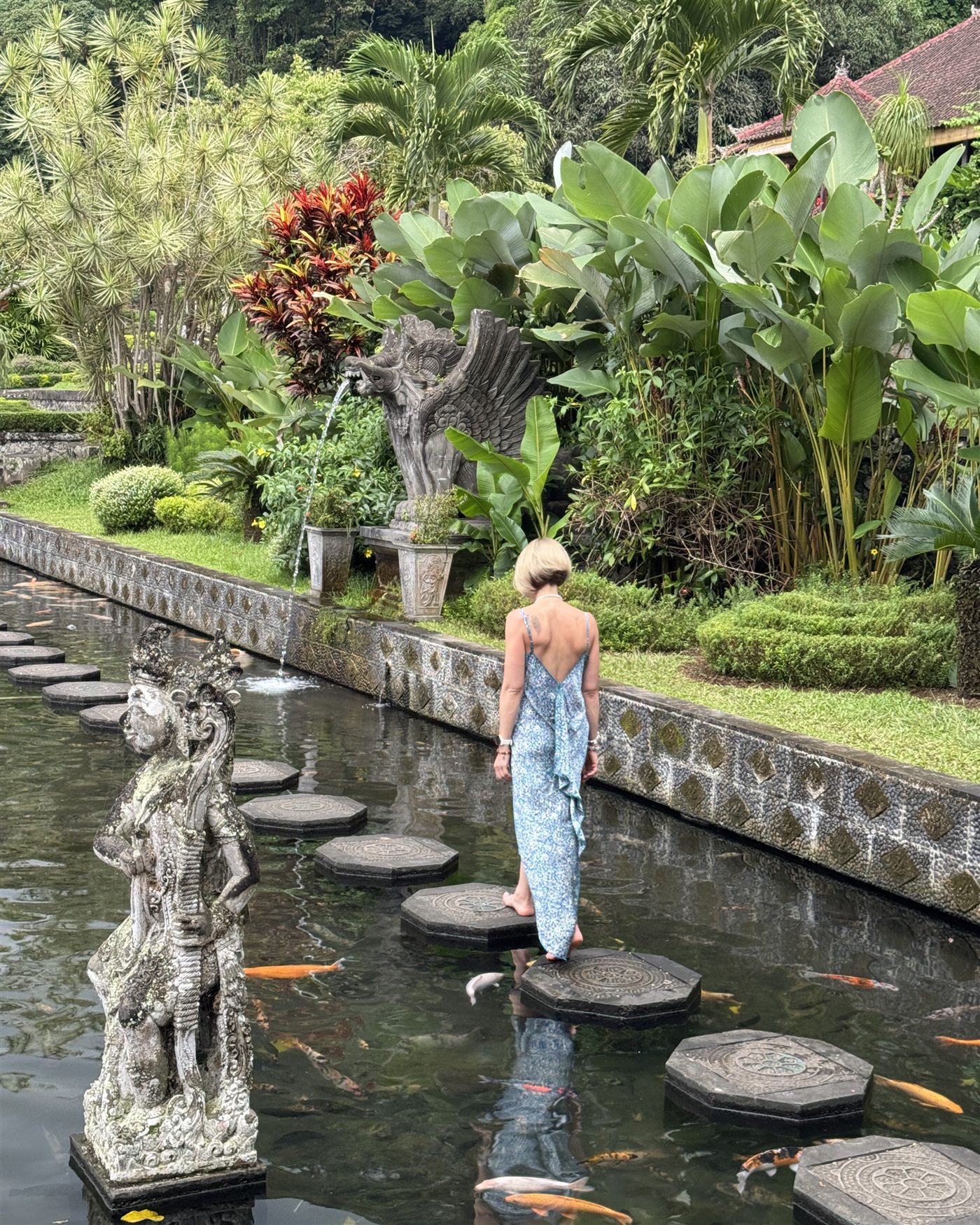 Walking the stone path across the water temple pool in Bali
