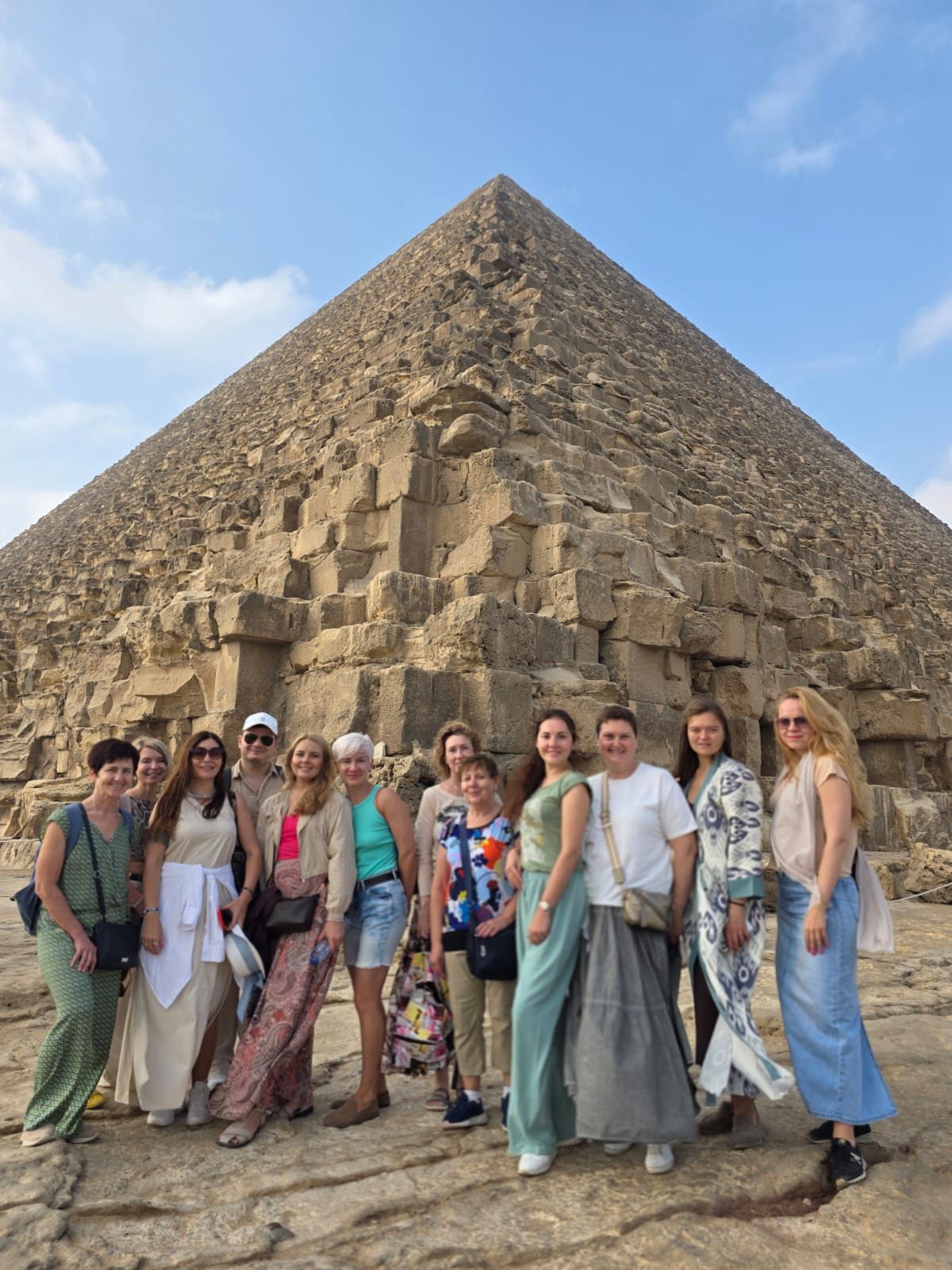 The group standing together at the foot of a pyramid in Egypt
