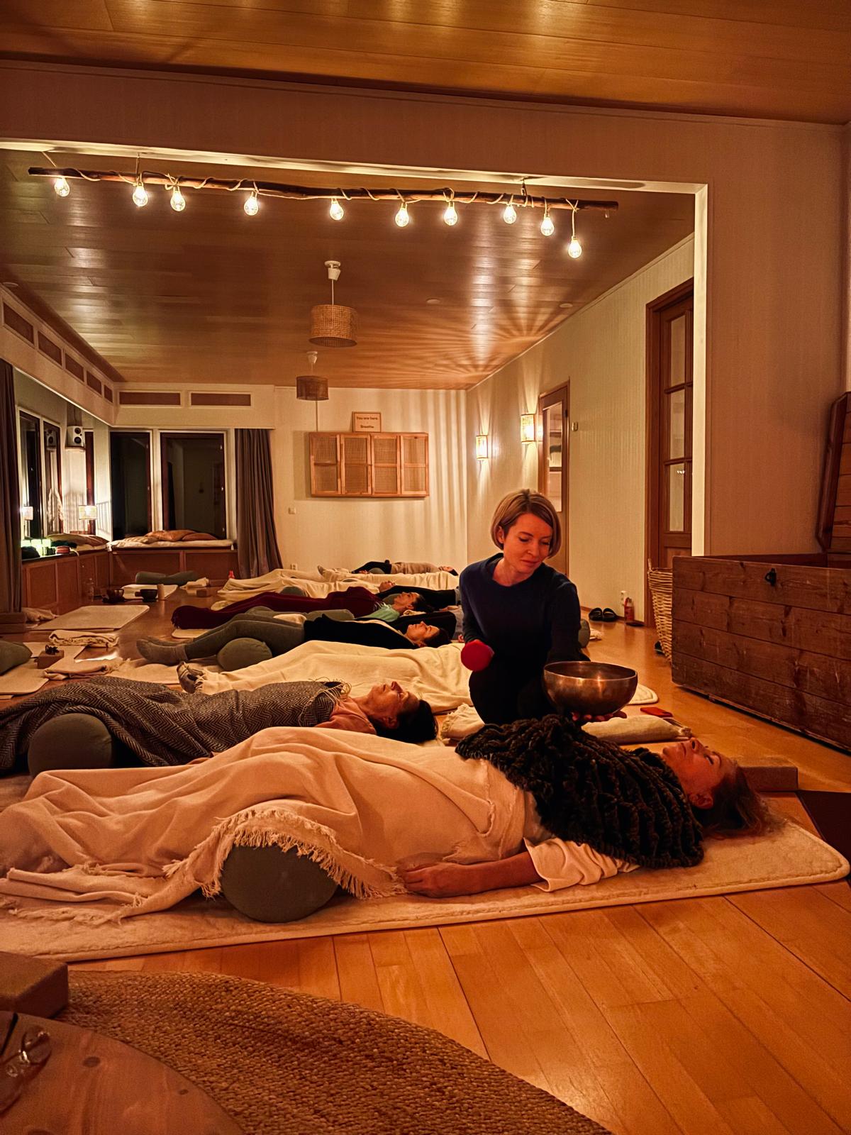 A sound practice: the group resting under blankets while a singing bowl is played