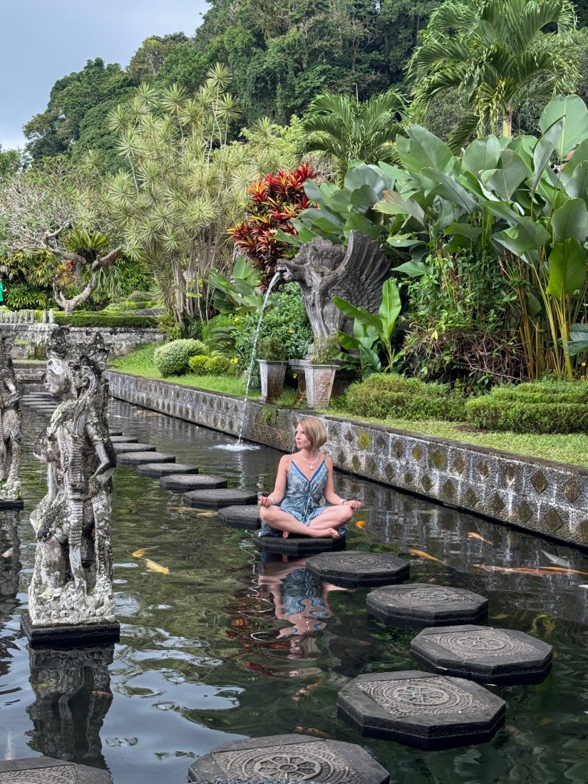 Meditating on the stepping stones at the water palace, koi in the pool